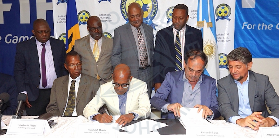 Barbados Football Association president Randolph Harris (second left) signs the MOU along with executive director of the Argentina Football Association Gerardo Leon (second right) while other officials look on. (Picture by Morissa Lindsay)