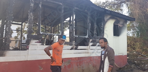 Residents Damion Jordan (left), and Fabian McDonald wish they could have done more to save 76-year-old Eric Fenty who perished in a house fire at Kew Road, Bank Hall, St Michael.