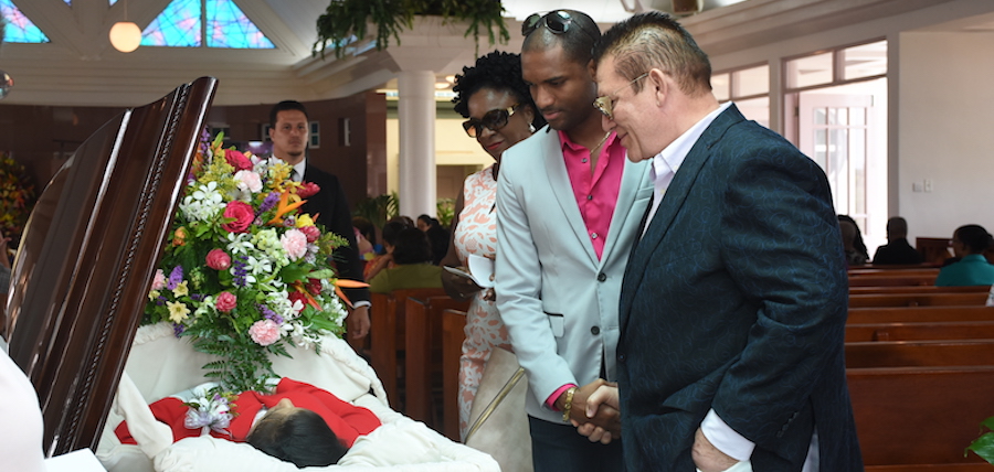 CEO and Chairman of Capital Media HD 99.3 Vic Fernandes (right) and Chrispen Hackett also of Capital Media fondly look at their friend as Chief Executive Officer of the Barbados Tourism Product Authority Dr Kerry Hall looks on.