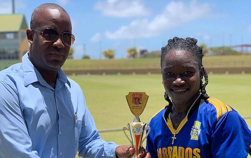 Deandra Dottin receiving her Player of the Match award from Arleigh Rutherford.