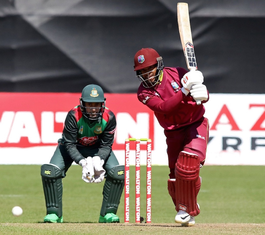 Opener Shai Hope drives down the ground during his 87 today. The wicketkeeper is Mushfiqur Rahim.