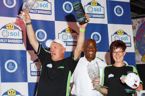 Third overall, winners of FIA R5 Andy Scott (left) and Laura Connell, also the highest-placed female co-driver, flank Sol Barbados General Manager Ezra Prescod. (Picture by Himal Reece)