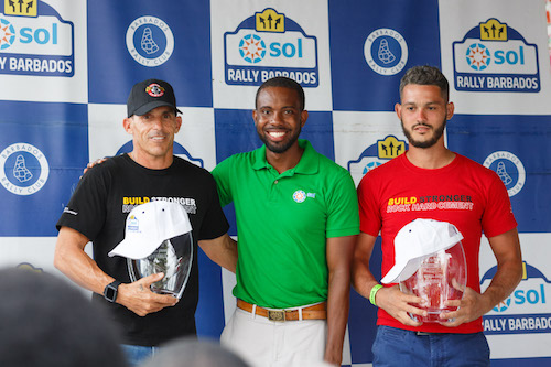 Top 2wd crew, Stuart (left) and Justin Maloney flank Sol Barbados Sales & Marketing Manager Mario Greene. (Picture by Himal Reece)