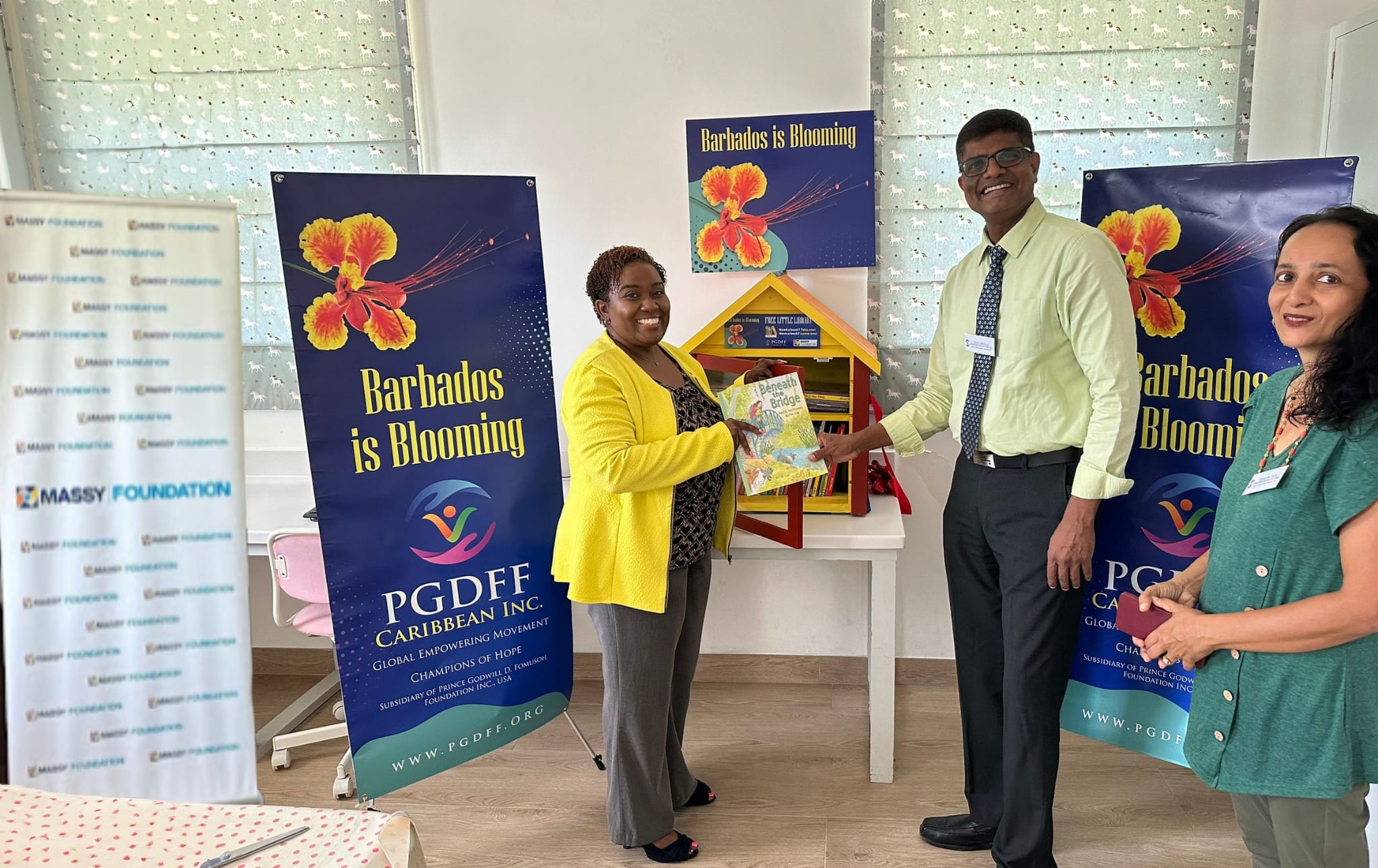 Installation_of_a_Free_Little_Library_at_a_Child_Care Board_home_Ms_Shelly_Anne_Weir_accepted_the_donation_on_behalf_of_PGDFF_Caribbean_who_were_represented_by_Dr_Kandamaran_and_Mrs_Sushma_Kini